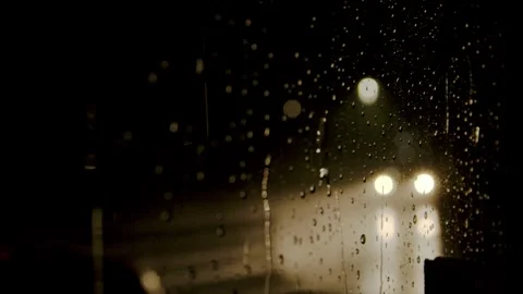 Rain on a window and Car driving in the night Stock Footage 253091958