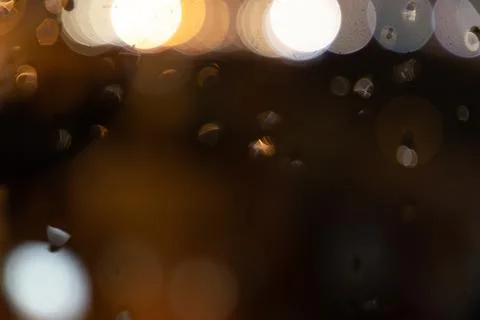 Rain on window and lights of the torches Stock Photos
