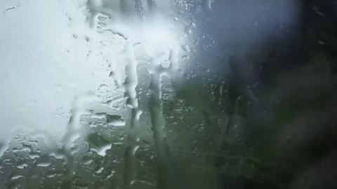 Rain on window of train slowing and stopping Stock Footage 76815736