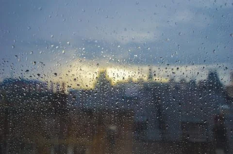 Rain on a window in an urban area with the distance out of focus Stock Photos