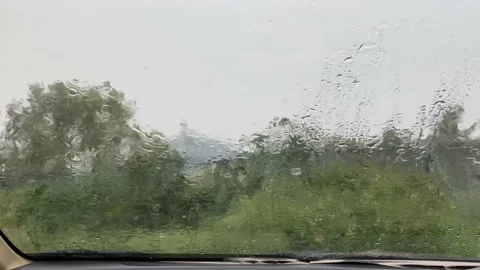 Rain on the windshield of a car on a rainy day Stock Footage 162979964