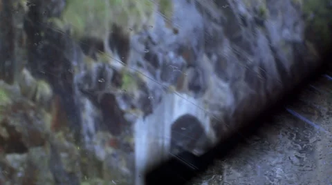 Rain on windshield, wiper and rocks in the background Stock Footage 39467335