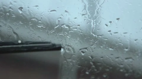 Rain on windshield with wipers in slow motion Stock Footage