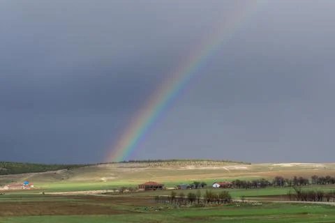 Rainbow above the field Stock Photos