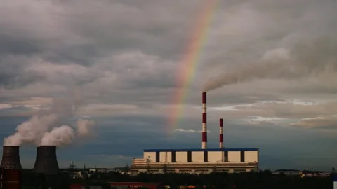Rainbow above power plant at evening Stock Footage