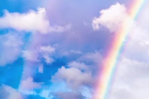 Rainbow after rain in a cloudy sky among clouds Stock Photos