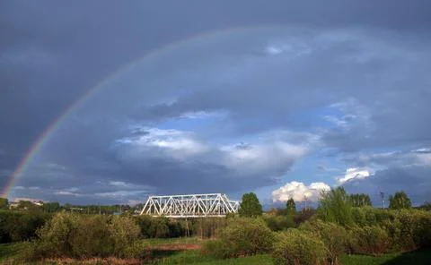 Rainbow, after a spring rain and thunderstorms against the background of a le Stock Photos