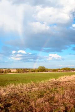 Rainbow against the blue sky with clouds after a spring rain. Foto stock