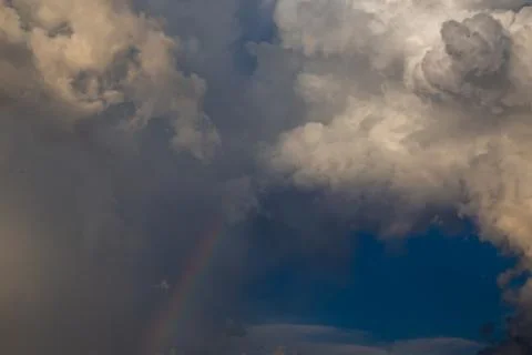 Rainbow amidst dramatic storm clouds Stock Photos