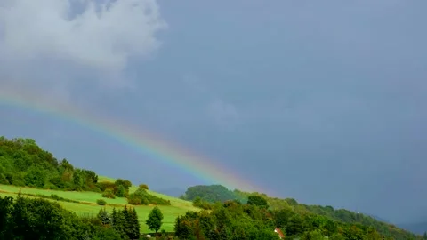 Rainbow and clouds over the hill - timelapse Stock Footage 139331883