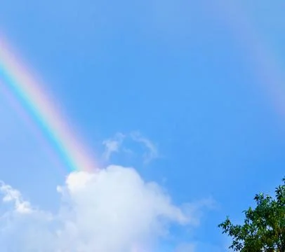 Rainbow and clouds Stock Photos
