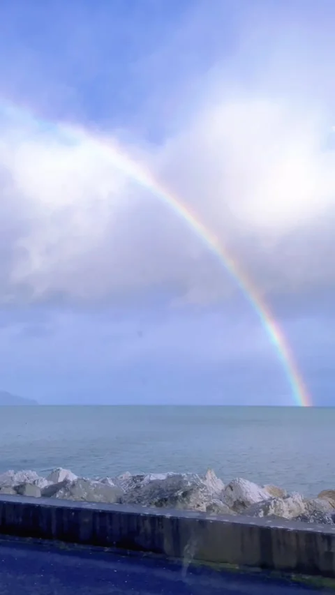 Rainbow and sea from a car window on a road in Northern Ireland. 스톡 동영상 260536409