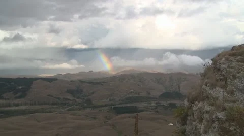 Rainbow and storm clouds timelapse Stock Footage 22339837