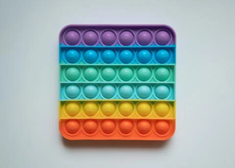 Rainbow antistress finger push toy for kids pop it isolated on white background Stock Photos