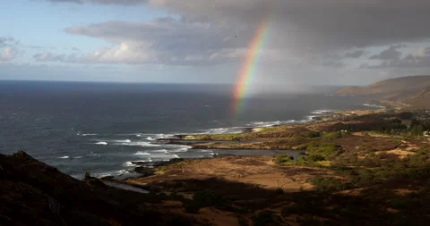A rainbow appears over the valley by the ocean in hawaii Stock Footage 171518727