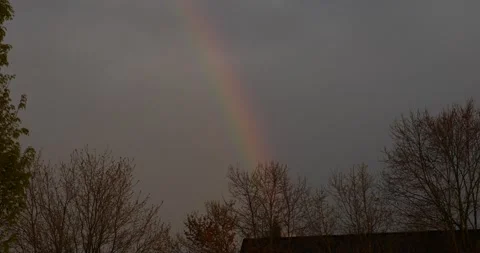 A Rainbow Appears in the Sky Over a House Stock Footage 262117889