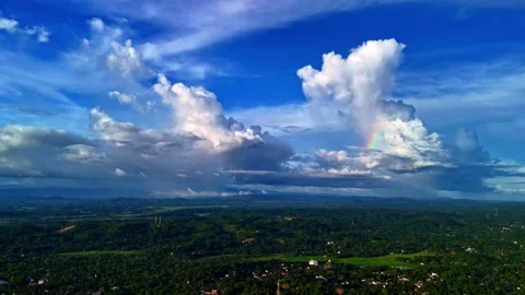 Rainbow Arcing Through Towering Clouds Above Tropical Sri Lankan Countryside Stock Footage 337503285