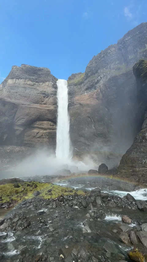 Rainbow arcs through the mist at the base of Háifoss waterfall near Hekla volcan Video stock 312232742