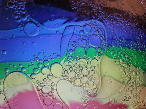 Rainbow background with bubbles, texture of water and oil drops. Stock Illustration