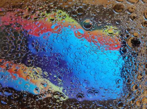 Rainbow background with bubbles, texture of water and oil drops. Stock Illustration