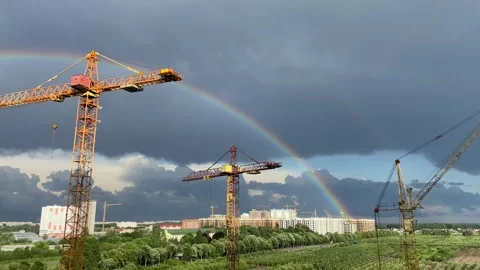 A rainbow on the background of a rainy sky. Rainbow and cityscape Stock Footage 277022691