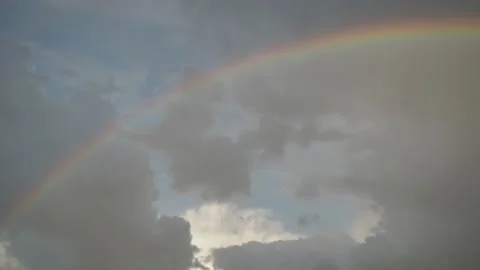Rainbow with beautiful clouds after rain. background. a little hazy Stock Footage 154892859