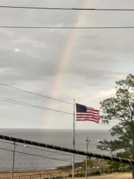 Rainbow behind Flag Foto stock