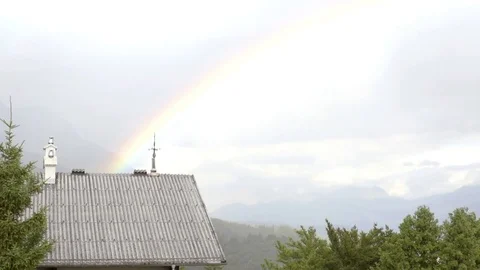 Rainbow behind the house with an amazing view to the nature on the background Stock Footage 81930617