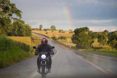 Rainbow behind motorcycle Stock Photos