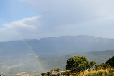 Rainbow between mountains Stock Photos
