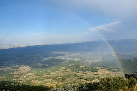 Rainbow between valleys and mountains, in autumn Stock Photos