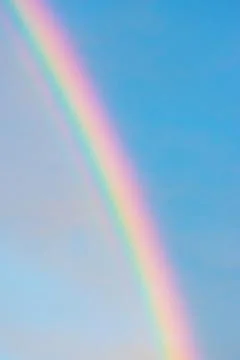 Rainbow in blue with clouds sky Stock Photos