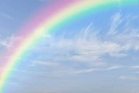 Rainbow on blue sky with white cloud background. Fotos de archivo