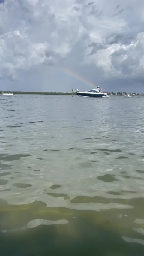 Rainbow with boat passing Stock Footage 170642413