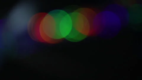 Rainbow bokeh light bubbles in a row on a black background Vidéo 309481386