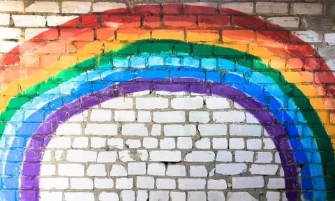 Rainbow on a brick wall. Red, orange, yellow, green, blue, indigo, purple colors Stock Photos