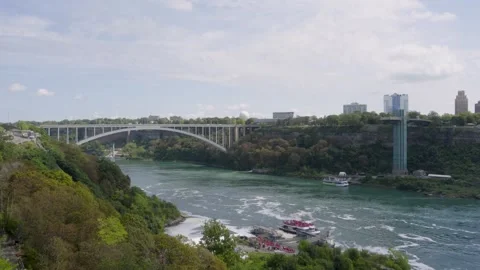 Rainbow Bridge and Niagara Falls Observation Tower Above Niagara River Stock Footage 346769157