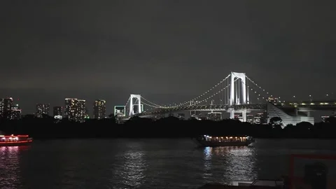 Rainbow Bridge illuminated at night over Tokyo Bay Stock Footage 326079193