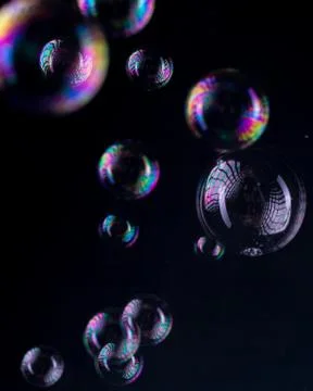 Rainbow bubbles on a black background Stock Photos