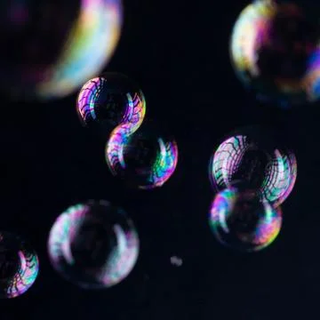 Rainbow bubbles on a black background Stock Photos
