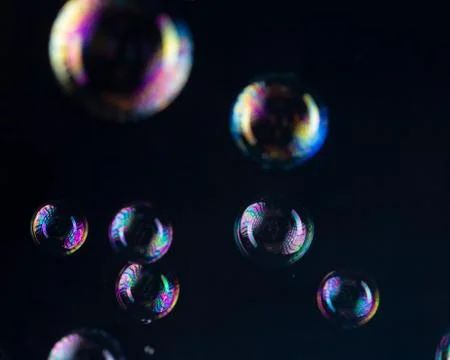 Rainbow bubbles on a black background Stock Photos