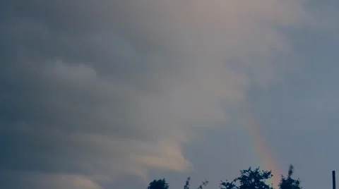 Rainbow, cloud looming over the rainbow Stock Footage 41387444