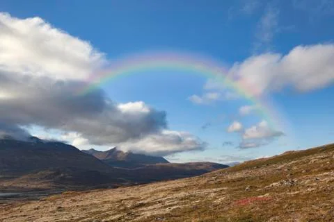 Rainbow with clouds in the mountains of Canada Stock Photos