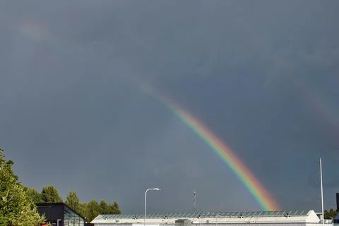Rainbow in a cloudy sky after heavy rain Foto stock