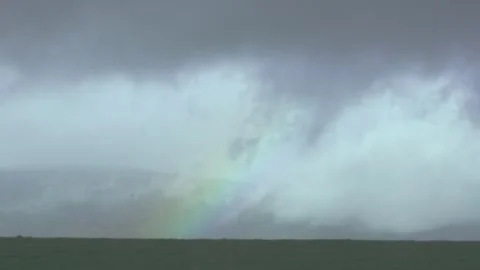 Rainbow in cloudy sky after rain Video stock 331038521