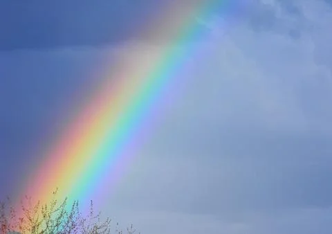 Rainbow in cloudy sky Stock Photos