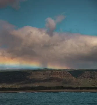 Rainbow in a cloudy sky Stock Photos