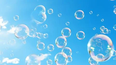 Rainbow color soap bubbles in clear summer sky. Kids fun activity holiday Stock-Fotos