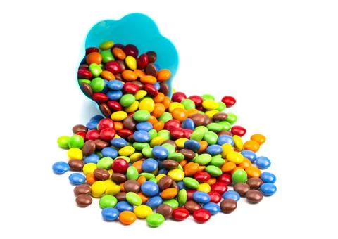 Rainbow Colored Candy Coated Chocolate Buttons in a Fun Blue Bowl Isolated on Stock Photos