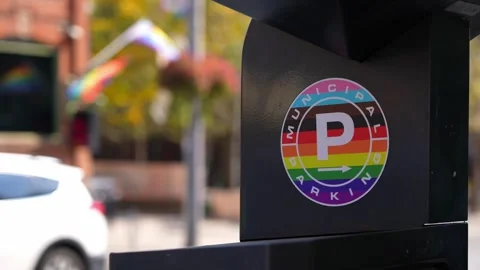 Rainbow-Colored Circle with Letter 'P' Displayed on a Parking Meter Stock Footage 257099508